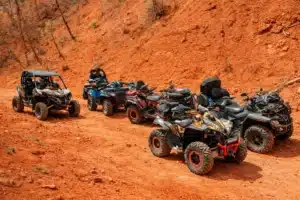 ATVs lined up on red Utah desert trail during off-road weekend adventure