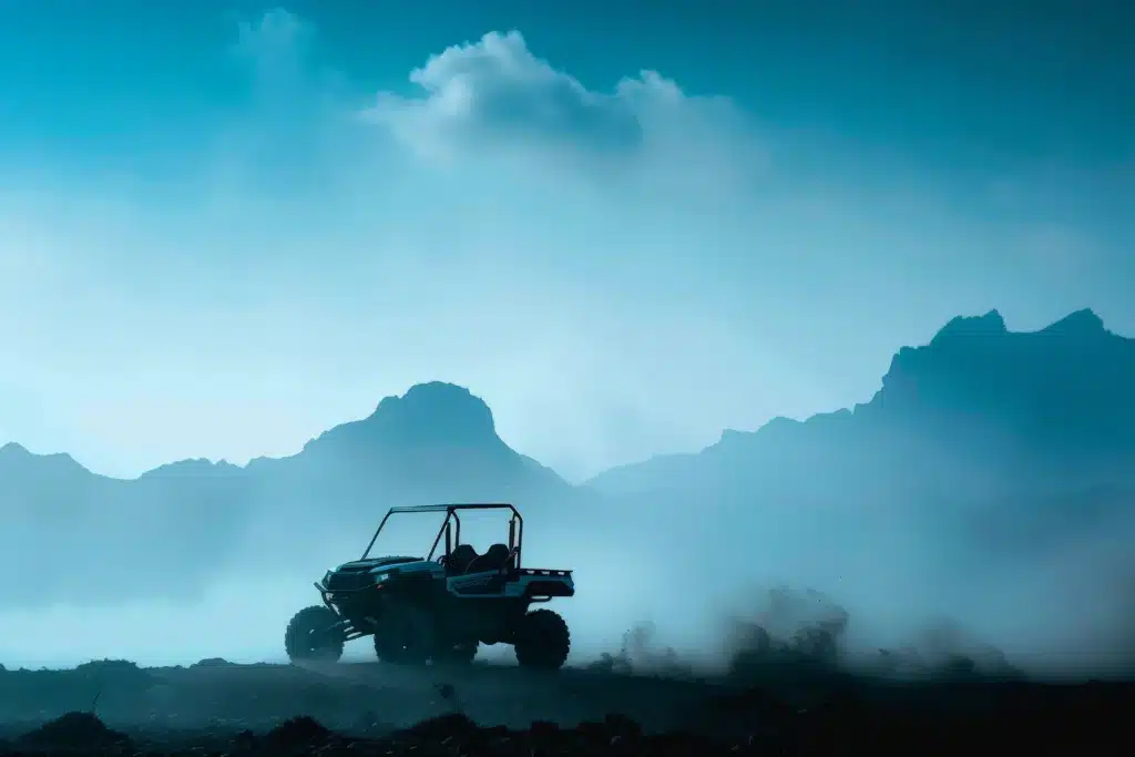 UTV parked in desert mountains and storm clouds in the background